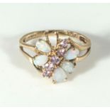 A 9ct gold ring set with opals and amethysts, one opal missing. 2.4gms