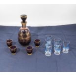 A gilt decorated decanter and four glasses together with six shot glasses