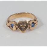 An 18ct gold ring set with two sapphires and a diamond, 5gms. No marks tested for 18ct.