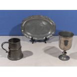 A pewter plate, musical tankard and a metal cup