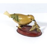 A vintage tin toy of a bird feeding her chick, base measures 7cm, the bird measures 10cm