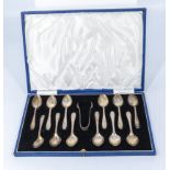 A cased set of silver coffee spoons and tongs, marks for Sheffield 1955 and 1957, makers mark EV