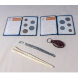 Two British coin folders, ivory glove stretchers silver comb edge and a Mulberry key fob