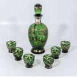 A gilt and green glass decanter and six glasses