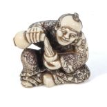 A fine quality antique Japanese mieji period carved ivory netsuke, depicting a Samurai drinking