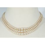 A triple string pearl necklace