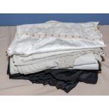 A bundle of black silk underskirts and fabric together with vintage white linen underwear