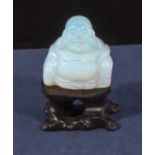 A moonstone Buddha and stand
