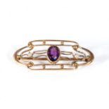 A small 18ct gold brooch set with and amethyst and seed pearls, 1.6gms