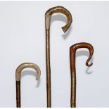 Three crooks two with horn handles, one modelled as a fish and one with a fruitwood handle.