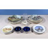 A collection of decorative plates and two blue glass dishes