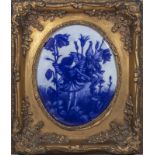 A blue and white pottery plaque depicting pixies, in a gilt frame, plaque 24cm x 19cm