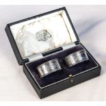 A pair of silver Edwardian napkin ring holders in original box, hallmarked Chester1911, in excellent