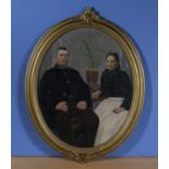 An gilt oval framed Victorian oil painting of a proud couple