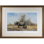 David Shepherd - A large framed print titled The Rhinos Last Stand, signed in pencil to border,