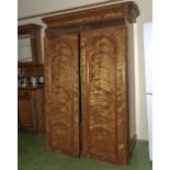 A satin wood double door wardrobe