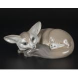 A Lladro figure of a fox and cub, 7" in length