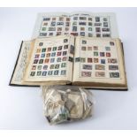 An album containing stamps together with a bag of assorted stamps