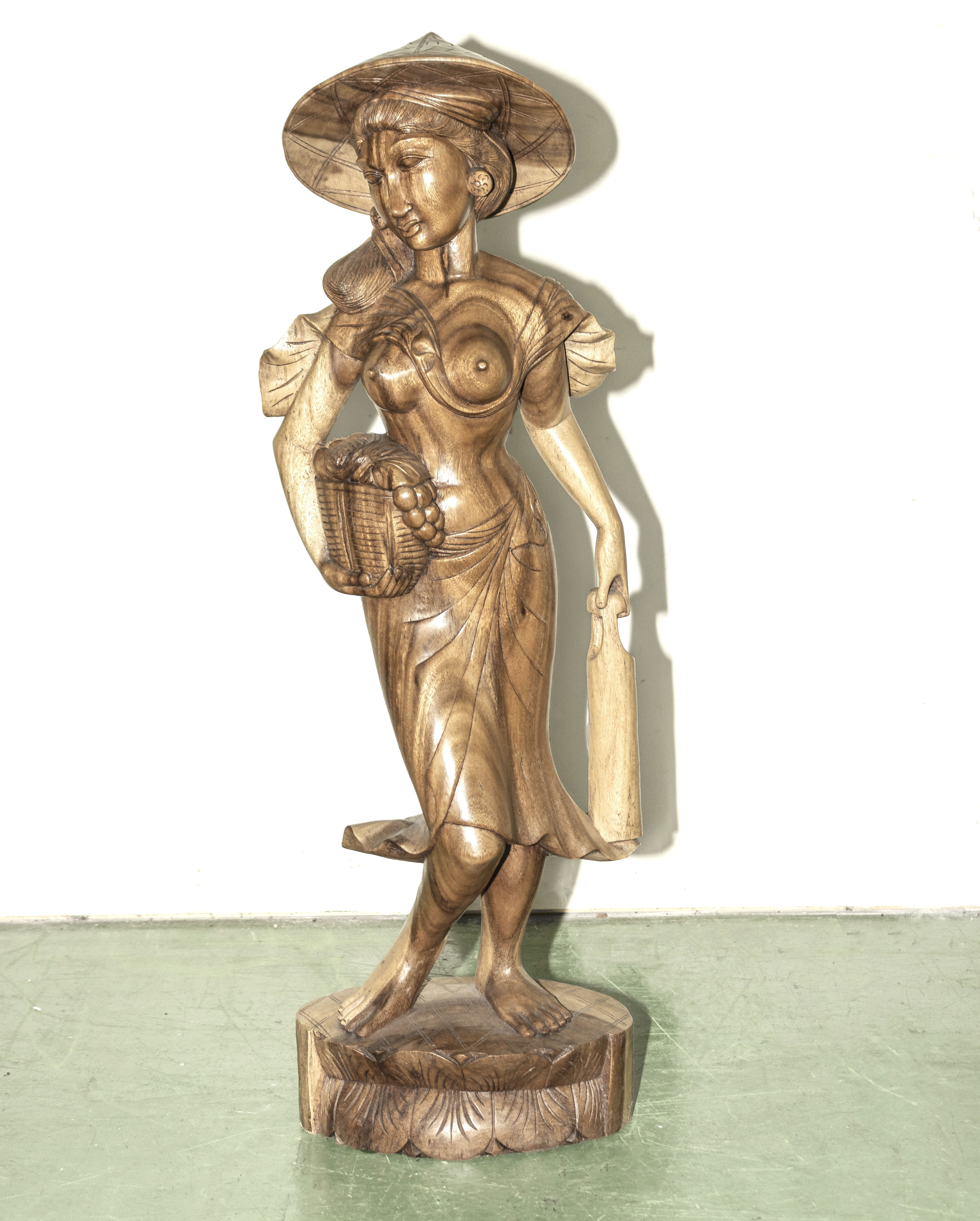 A carved wood Balinese figure of a lady 40" tall