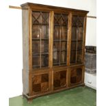 A 1930's three door display cabinet in mahogany. 64" wide x 14" deep x 76" tall