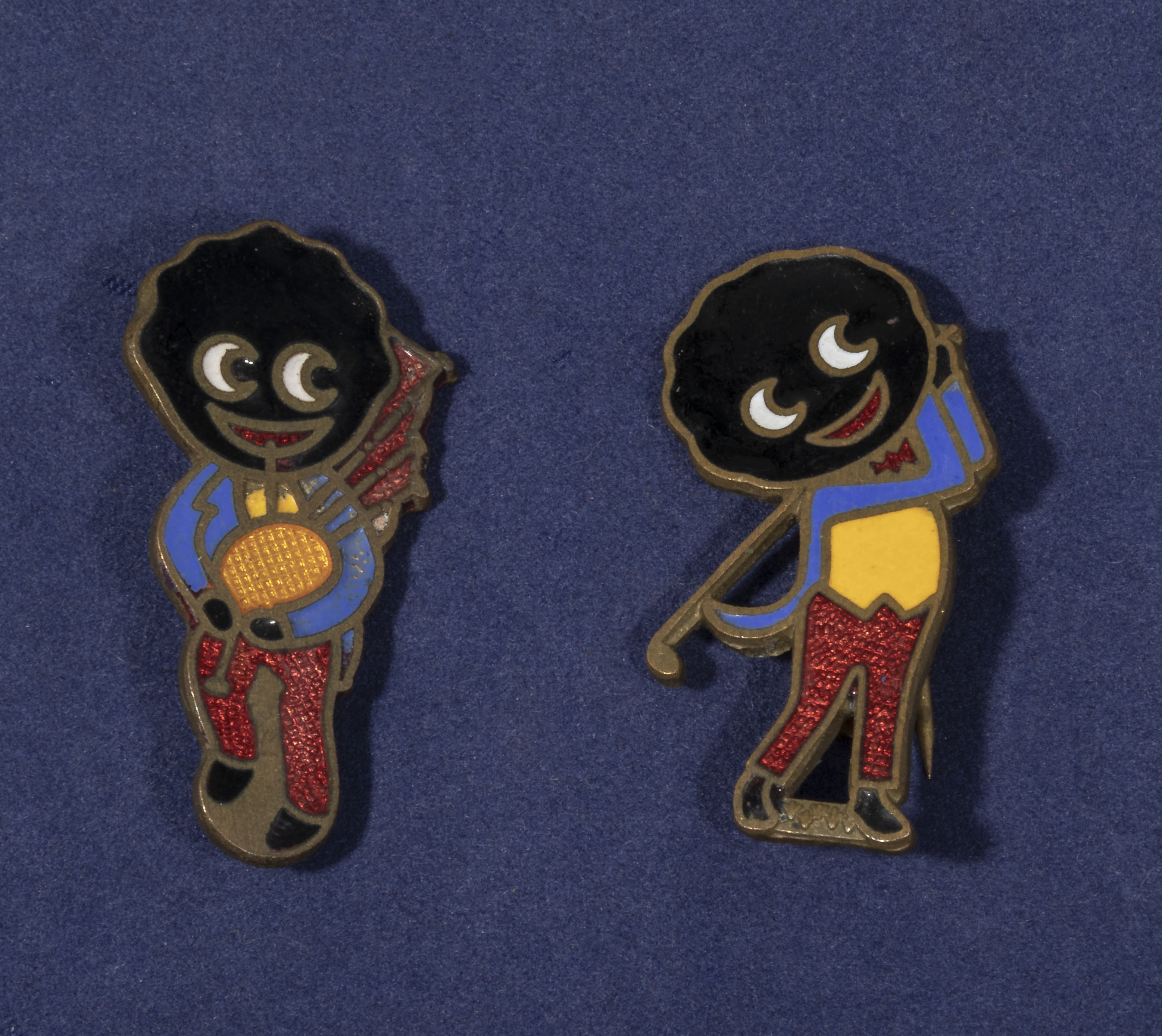 Two vintage enamel Robertsons jam badges, a golf player and bagpipe player made by R.E.M Gomm