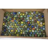 A bag full of hundreds of single coloured cats eye vintage marbles