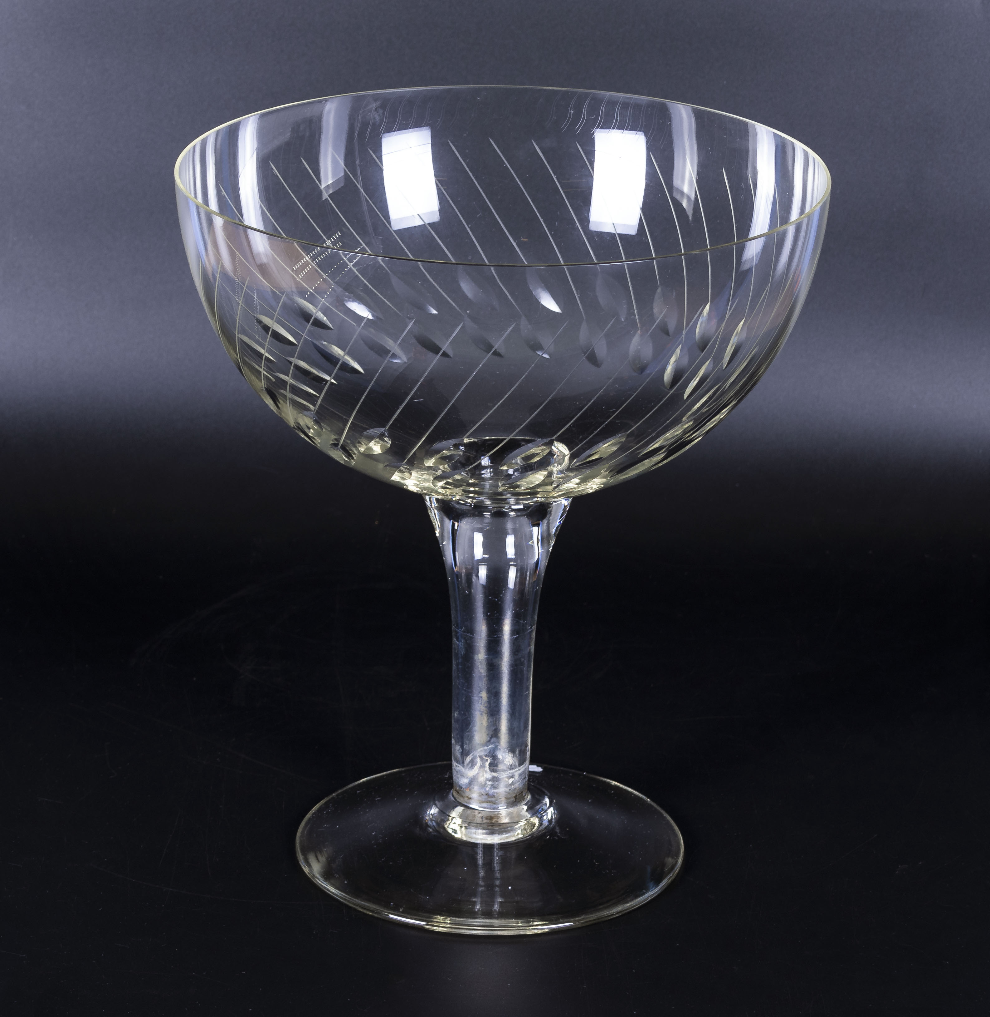 A large hollow stem champagne style glass, 10" tall