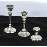 Three odd silver candle-sticks. 6"-5"-3" high dates Birmingham 1922 London 1933 and Birmingham 1942.