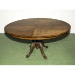 A Victorian oval tilt top table on four splayed feet, 4'3" long x 3;3" wide