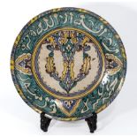 Islamic antique pottery decorated dish, with Arabic text to the borders, the centre with floral