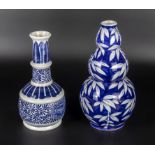 A 20th century blue and white double gourd vase together with one other, 26cm