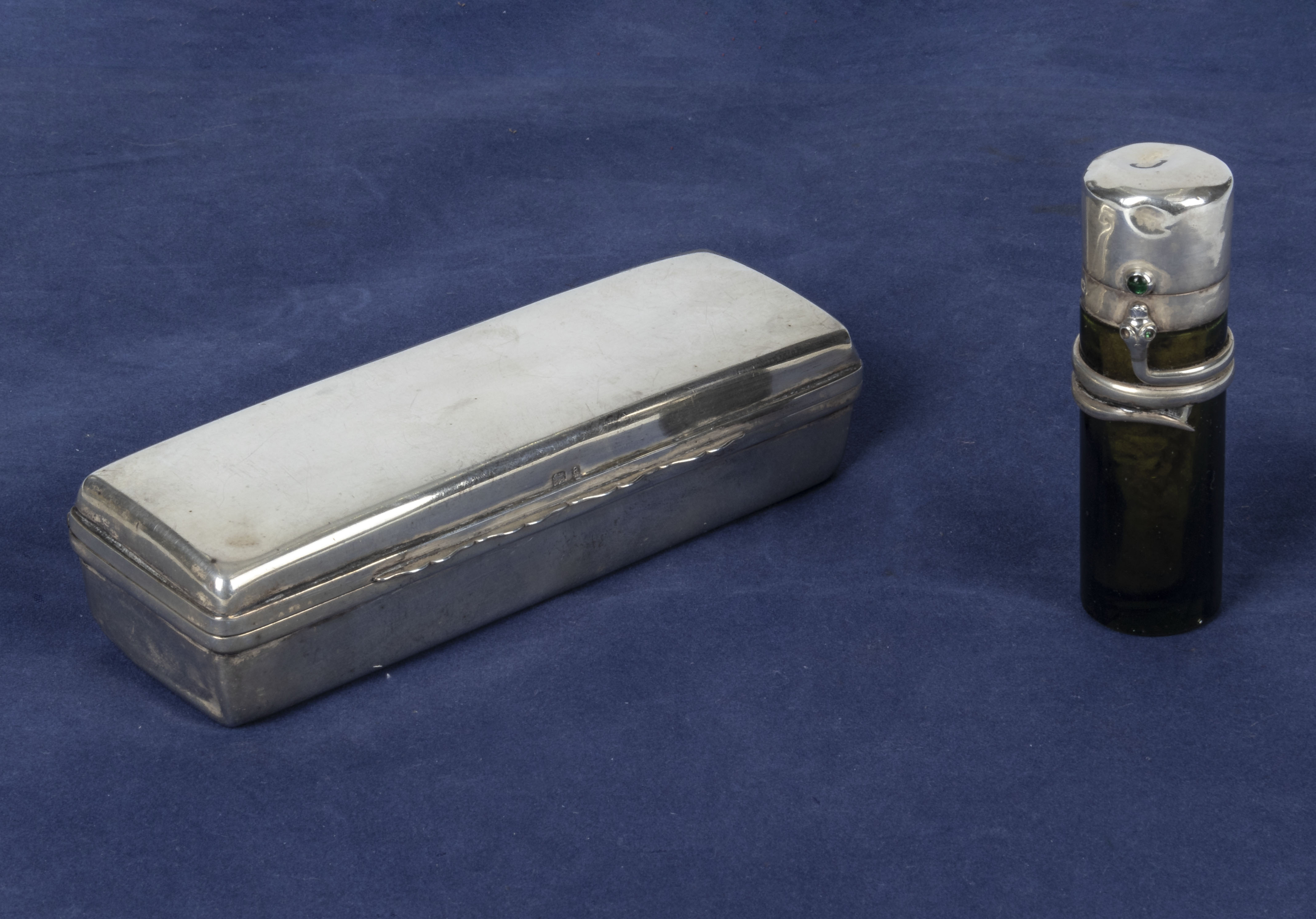 A small silver box together with a silver topped perfume bottle