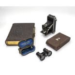 A photograph album, Brownie camera and a pair of opera glasses