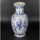 A Chinese 20th century white ground vase decorated with blue birds and foliage in panels, 30cm