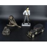 Three figures and a model car