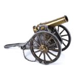 A large brass and metal cannon, 40cm long