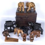 A collection of wood and china elephants together with a wooden box