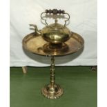 A small brass table together with a brass kettle