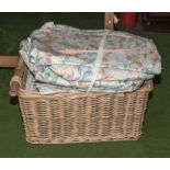 A basket containing three pairs of curtains