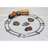 A tin plate wind up train and track together with two Civil Defence Corp sleeve badges and a railway