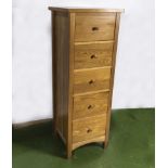 A tall oak chest of five drawers 1.3m high x 48cm square