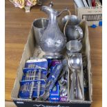 A box containing cutlery and pewter items