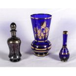 Two blue and gilt glass vases and a decanter