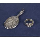 A silver miniature hand mirror and a silver puzzle ring