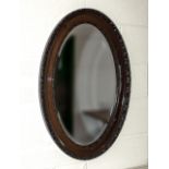 A mahogany oval mirror 82cm x 54cm