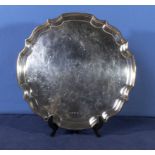 A silver salver with scalloped edge on small feet. Makers mark J R Birmingham 1969. 14" diameter