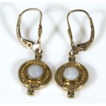 A pair of 9ct gold earrings set with opals