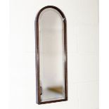An arch shaped mahogany wall mirror, 66cm x 23cm
