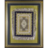 A large framed embroidery, gold thread and semi precious stones on a blue velvet background