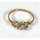 A 9ct gold twist ring set with four diamonds, UK size O
